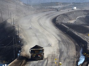 A heavy hauler truck and several other vehicles leave Suncor's North Steepbank Mine, located north of Fort McMurray, Alta., on Wednesday September 27, 2017. File photo.