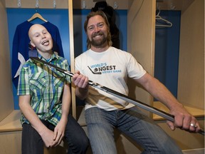 World's Longest Hockey Game launch Dr. Brent Saik, right, and Jordan Iszcenko, diagnosed with cancer in Grade 10, pose for a photo in Dr. Saik's hockey dressing room on Thursday, Nov. 23, 2017 north of Sherwood Park.