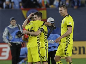 Columbus Crew's Hector Jimenez (16) embraces teammate teammate Wil Trapp (20) after losing to New York City FC in an MLS Eastern Conference semifinal soccer match Sunday, Nov. 5, 2017, in New York. New York City FC won 2-0, but the Crew advances to the conference championship with a 4-3 aggregate score. (AP Photo/Mark Lennihan)