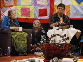 Elders light a qulliq at a public hearing for the National Inquiry into Missing and Murdered Indigenous Women and Girls, in Edmonton on Nov. 7, 2017.