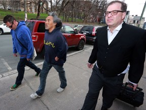 Minister of the Nunatsiavut Assembly Danny Pottle, left, plaintiff Toby Obed, and lawyer Steven Cooper arrive at the Supreme Court in St. John's on Tuesday, May 10, 2016. The plaintiffs of a class action lawsuit were looking for an apology and damages after they were excluded from a federal apology and compensation deal regarding residential schools in Newfoundland and Labrador.