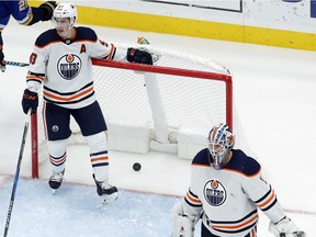 Edmonton Oilers goalie Laurent Brossoit, right, and Ryan Nugent-Hopkins, left, during NHL action on Nov. 21, 2017, in St. Louis.
