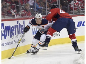 Edmonton Oilers center Connor McDavid (97) skates with the puck against Washington Capitals defenseman Brooks Orpik (44) during the first period of an NHL hockey game, Sunday, Nov. 12, 2017, in Washington.