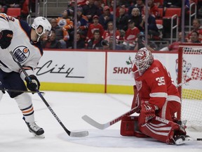 Edmonton Oilers left wing Patrick Maroon (19) shoots the puck past Detroit Red Wings goalie Jimmy Howard (35) during the first period of an NHL hockey game, Wednesday, Nov. 22, 2017, in Detroit.