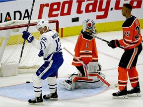 Toronto Maple Leaf Patrick Marleau (left) skates past Edmonton Oiler goalie Laurent Brossoit and defenceman Darnell Nurse after scoring late in the third period during NHL game action in Edmonton on Thursday November 30, 2017.