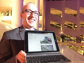 Coun. Andrew Knack with a website showing pictures of a trackless train being tested in China.