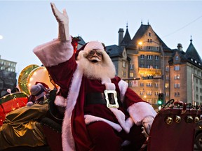 Santa Claus waves to the crowd during the Parade of Lights along Jasper Avenue in Edmonton, Alta., on Saturday, Nov. 21, 2015.