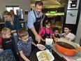 Nik Manojlovich, Gemini Award-winning host helps some of the children make their chocolate bananas as the Jasper Place Lodge once again hosted a festive meal to families at Ronald McDonald House in Edmonton, Nov. 1, 2017.