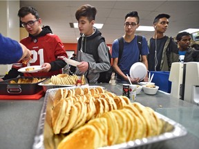 Students at M.E. LaZerte School line up for breakfast as part of the school's nutrition program.