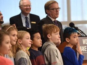 Surrounded by school children, Education Minister David Eggen announces government support for two Edmonton Catholic Schools projects at Father Michael Mireau Elementary in Edmonton on Nov. 29, 2017.