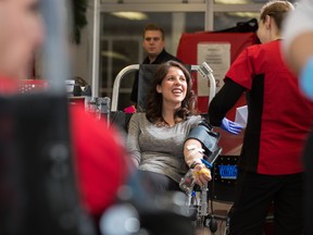 Jennifer McNalley, an instructor at NAIT, rolls up her sleeves to donate blood for her colleague and friend, Charles Neher, who was injured when an almost 15-metre poplar fell on him in July. He spent about four months in the hospital and was sent home this month.