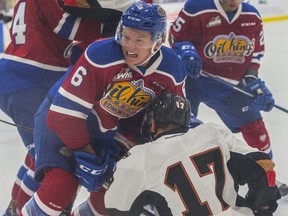 Wyatt McLeod of the Edmonton Oil Kings, tries to move Bryce Bader of the Calgary Hitmen out of the crease at the Community Rink in Rogers Place in Edmonton on September 10, 2017.