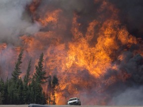 A giant fireball is seen as a wild fire rips through the forest 16 km south of Fort McMurray on highway 63 Saturday, May 7, 2016. File photo.