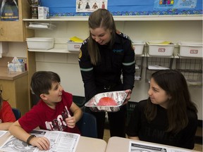 Grade 4 student Jaxon McKay reacts after touching a "gelatin brain" given to him by Alberta Health Services advanced care paramedic Jillian Danko at Clara Tyner School during the Brain Waves program on Friday, Dec. 1, 2017.