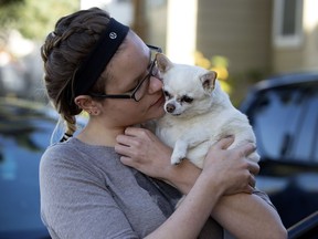 Erinne Evenson holds her dog Tiger as she waits to see a vet at the Mustard Seed Church, 10635 96 St., in Edmonton Tuesday Sept. 26, 2017. The Mustard Seed was partnering with Vets To Go to offer free vet care help to struggling Edmontonians and their pets.