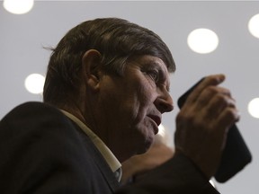 Tom Ruth, Edmonton International Airport President and CEO, holds up his cellphone as he speaks to the media after taking part in a panel discussion on how digital services and artificial intelligence will affect the future of air travel in Edmonton Monday, Dec. 11, 2017.