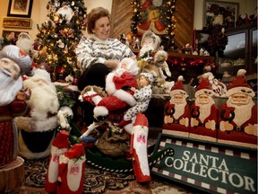 Bernice Gordeyko poses for a photo with a small portion of her huge Santa Claus collection in Edmonton, Alta. Tuesday Dec. 19, 2017.