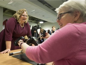 Health Minister Sarah Hoffman (left) chats with Moving for Memory program participant Mae Gerow, as she uses an arm ergometer at the Edmonton Southside Primary Care Network, 3110 Calgary Trail, in Edmonton Tuesday, Dec. 19, 2017. Hoffman unveiled Alberta's new provincial dementia strategy during a press conference at the centre Tuesday.