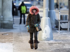 A pedestrian makes their way through the bitter cold near Jasper Avenue at 101 Street in Edmonton Thursday, Dec. 28, 2017.