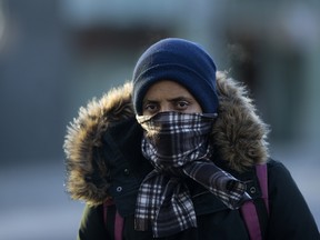 A pedestrian makes their way through the bitter cold near Jasper Avenue at 101 Street in Edmonton Thursday, Dec. 28, 2017.