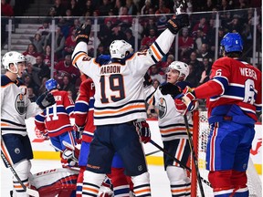 Michael Cammalleri #13 of the Edmonton Oilers (R) celebrates his first period goal with teammates Patrick Maroon #19 and Ryan Nugent-Hopkins #93 of the Edmonton Oilers against the Montreal Canadiens during the NHL game at the Bell Centre on December 9, 2017 in Montreal.