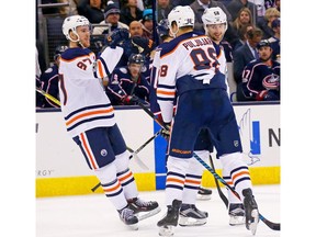 Connor McDavid (97) of the Edmonton Oilers celebrates Jesse Puljujarvi's (98) goal against the Columbus Blue Jackets on Tuesday, Dec. 12, 2017, at Nationwide Arena in Columbus, OH. Edmonton defeated Columbus 7-2.