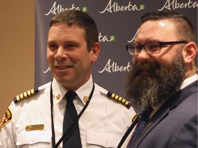 Rodney Schmidt (left), fire chief and director of protective services for the town of High Level, Alta., poses for a photo with Shaye Anderson, Alberta's minister of municipal affairs before accepting an award for the creation of a new Regional Incident Management Team that will offer backup to small northern municipalities dealing with large-scale emergencies on Tuesday, Dec. 5, 2017.