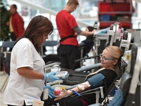 Susana Potter, a phlebotomist (one who draws blood), attends to Cindy Taylor who is giving blood during the Canadian Blood Services donor clinic at City Hall in Edmonton, Thursday, March 23, 2017.