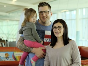 Parents Jeff Forsythe and Keisha Mouland with toddler Reeve at the Edmonton International Airport on Wednesday,  Dec. 20, 2017.