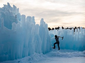 A worker in a T-shirt works on the Ice Castles at Hawrelak Park in Edmonton on Saturday, Dec. 9, 2017.