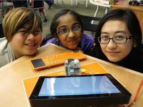 Neeysa Cruz, 10, Sudiksha Singhal, 11, and Kirsten Kwong, 20, made a miniature computer camera at the Rasberry Jam Youth Workshop held at the downtown Edmonton Public Library branch on June 18, 2016. File photo.