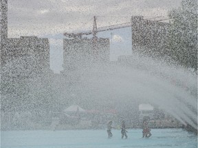 The pool in front of Edmonton's city hall obscured by the fountain stream of water on July 5, 2017.