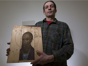 Icon writer Oleksandr Klymenko with his work written on former ammunition boxes brought over from Ukraine.