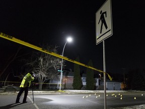 Edmonton Police Service officers investigate a hit-and-run at 96 Street and 71 Avenue on Wednesday, Dec. 13, 2017.