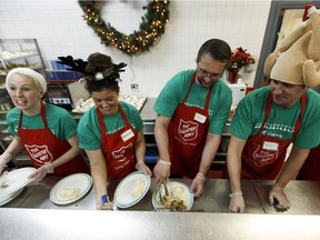 Volunteers prepare and serve turkey dinner during the Salvation Army's annual Community Christmas dinner at the Addictions and Residential Centre in Edmonton on Tuesday, Dec. 19, 2017.
