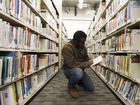 Abdulhadi Telsem searches the shelves for a book at Edmonton Public Library's Entreprise Square Branch at 10212 Jasper Avenue in Edmonton, Alberta on Tuesday, Jan.3, 2017.