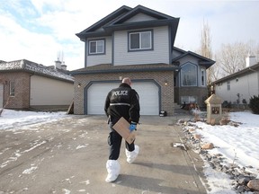 A police investigator at a Lewis Estates house at at 875 Proctor Wynd on Friday, Dec. 22, 2017, following a break-in and shooting on Thursday, Dec. 21, 2017.