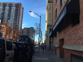 A police officer in front of Centre High the day after a teacher was stabbed in the Mill Creek neighbourhood.