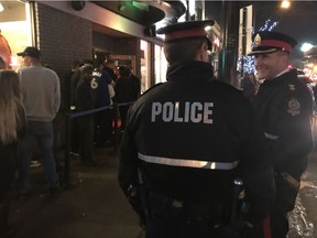 Sgt. Michael Elliott, left, and southwest division Supt. Tom Pallas walking the beat outside Beercade on Whyte Avenue. Between five and eight beat cops patrol the entertainment district on foot.