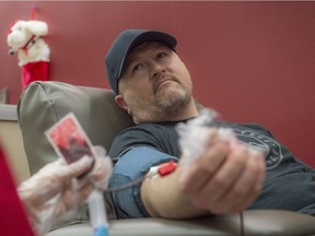 Kevin Cornish gives blood at Canadian Blood Services in Edmonton on Dec. 13, 2017. His seven-month-old son Nolan is in hospital.