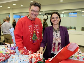 Scott Foster, left, vice-president of operations at Spartan Controls, and Alberta Children's Services Minister Danielle Larivee with some of the Christmas gifts on Wednesday, Dec. 20, 2017 that will be delivered to families in need. Spartan Controls, an Alberta-based oilfield equipment supplier, have purchased gifts for families supported by Alberta Children's Services.
