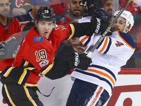 Flames Matthew Tkachuk (L) mixes it up with Oilers Kris Russell during NHL action between the Edmonton OIlers and the Calgary Flames in Calgary Saturday, December 2, 2017.