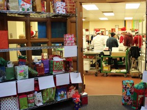 Gifts are arranged outside the main kitchen of the Edmonton Meals on Wheels as volunteers and special guests prepare meals for delivery at 11111 103 Ave. in Edmonton on Tuesday, Dec. 19, 2017.