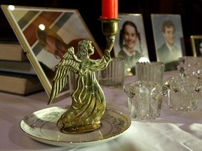 An angel candle holder beside photos of victims killed by drunk drivers on display at the Edmonton and Area Chapter of MADD (Mothers Against Drunk Driving) candlelight vigil and service held at Holy Trinity Anglican Church in Edmonton on Sunday Dec. 10, 2017.