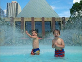 Waylon Wojdanski, 6, and his five-year-old brother Winston (right) play in the City Hall fountains August 2017. Father Mark Wojdanski told Postmedia the boys love the wading pool because it's the perfect depth.