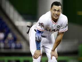 FILE - In this Aug. 14, 2017, file photo, Miami Marlins' Giancarlo Stanton stands on the field during a baseball game against the San Francisco Giants in Miami. A person familiar with the negotiations says the New York Yankees and Miami Marlins are working on a trade that would send slugger Giancarlo Stanton to New York and infielder Starlin Castro to Miami. The person spoke to The Associated Press on condition of anonymity Saturday, Dec. 9, 2017, because no agreement has been completed.