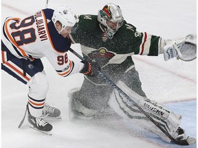 Edmonton Oilers' Jesse Puljujarvi (98) tries to get the puck past Minnesota Wild's goalie Alex Stalock on Saturday, Dec. 16, 2017, in St. Paul, Minn.