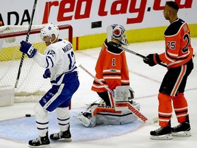 Toronto Maple Leaf Patrick Marleau (left) skates past Edmonton Oiler goalie Laurent Brossoit and defenceman Darnell Nurse after scoring late in the third period during NHL game action in Edmonton on Thursday November 30, 2017.