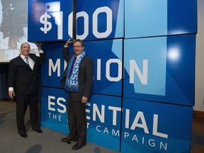 A file photo from November 2014 shows NAIT President and CEO Glenn Feltham (left) and Fountain Tire CEO Brent Hesje, then-chair of the NAIT Board of Governors (right), take part in NAIT's $100 million fundraising campaign launch.