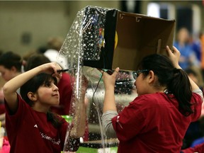 Medina Qasqas (l) and Saja El-haj from Mac Islamic School work on their project at the APEGA Science Olympics at the Shaw Conference Centre in Edmonton, Alberta on Saturday Feb. 28, 2015. File photo.